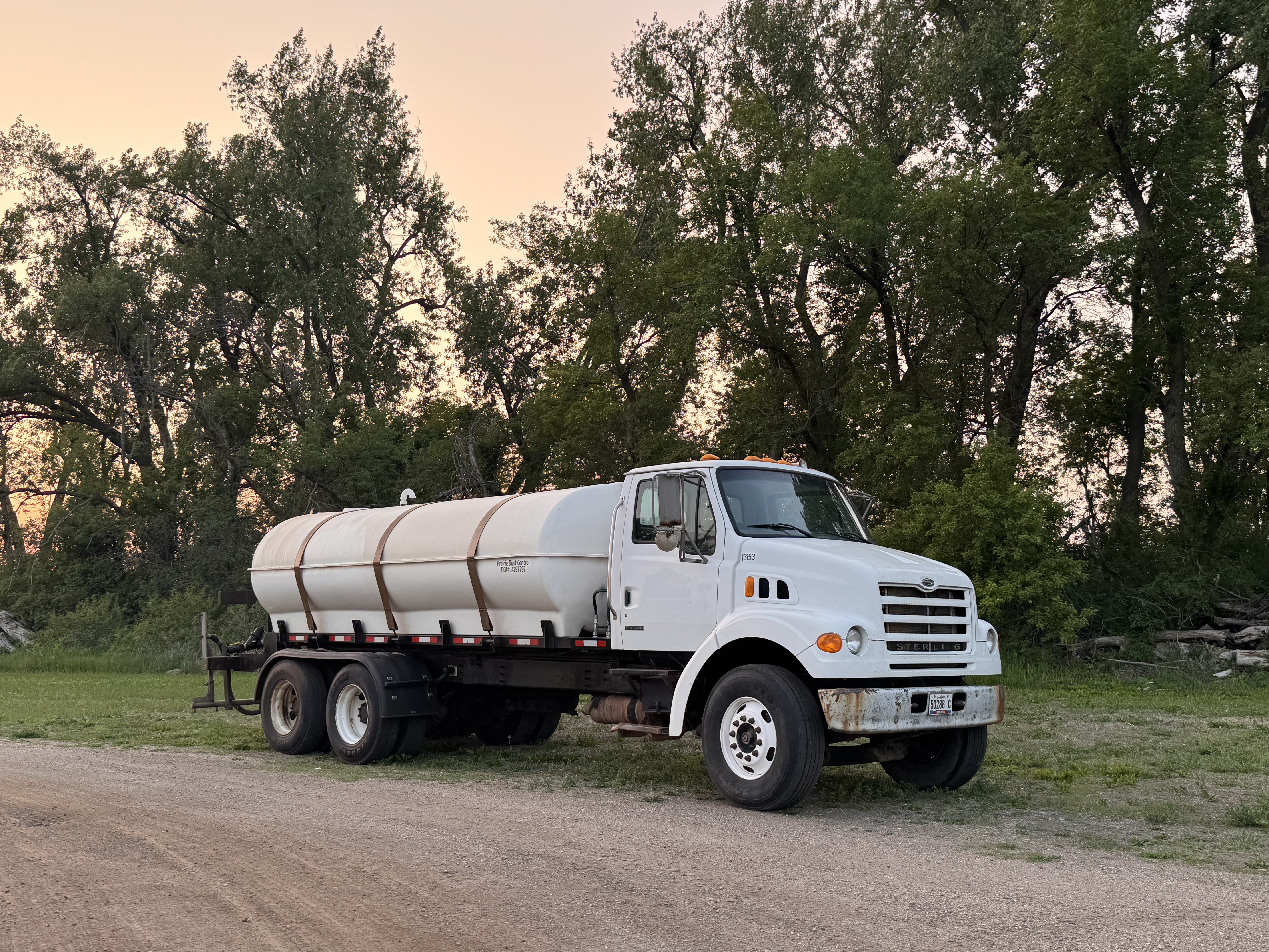 Dust control application truck on gravel road