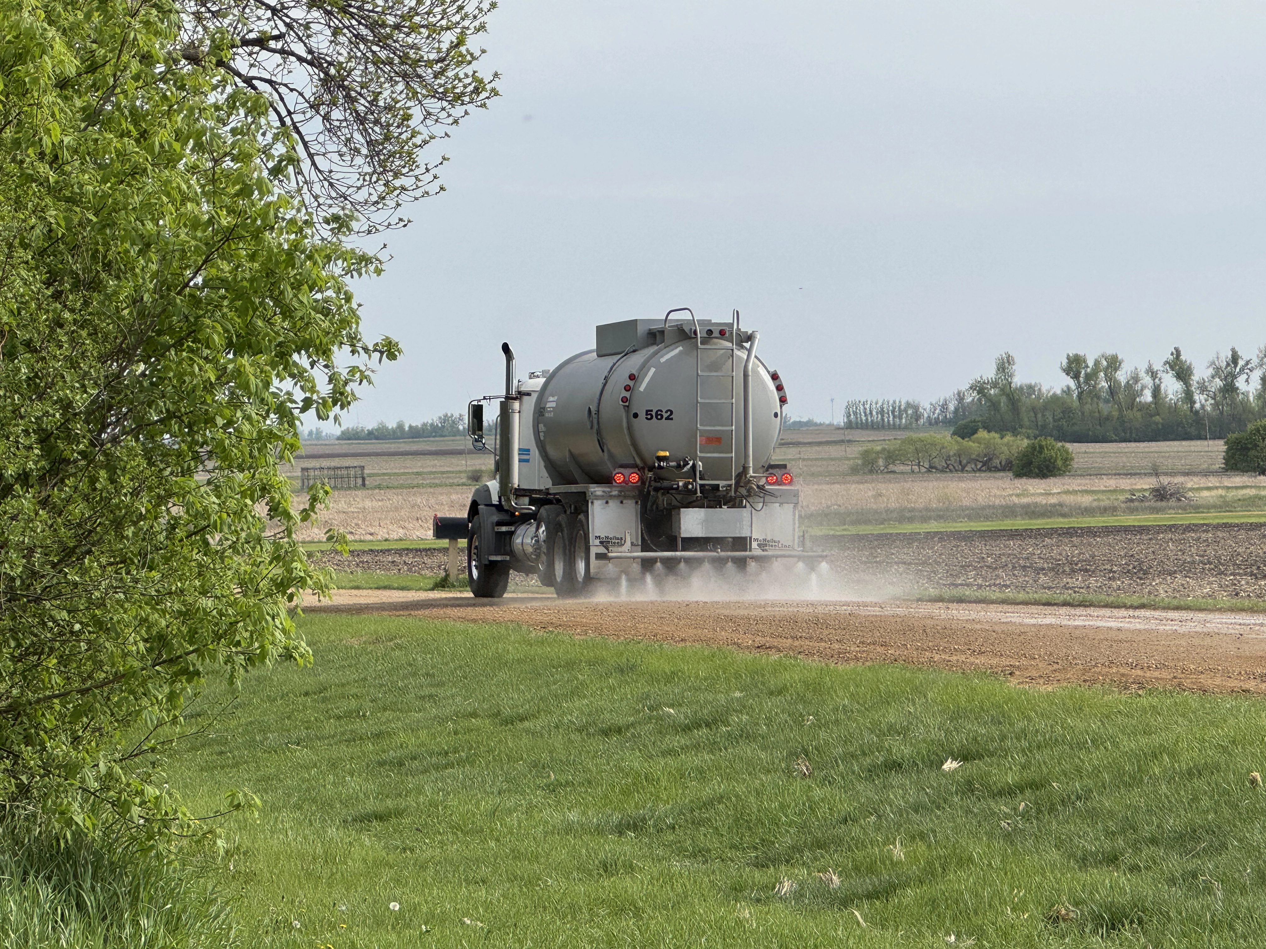 Dust control application truck on gravel road
